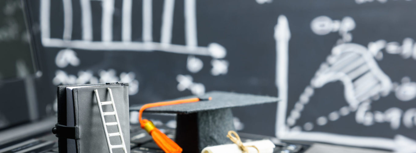 Graduate certificate program concept : Black graduation cap, a diploma, white ladder, a small book on a table, depicts an attempt for students to achieve the goal or gain success in higher education.