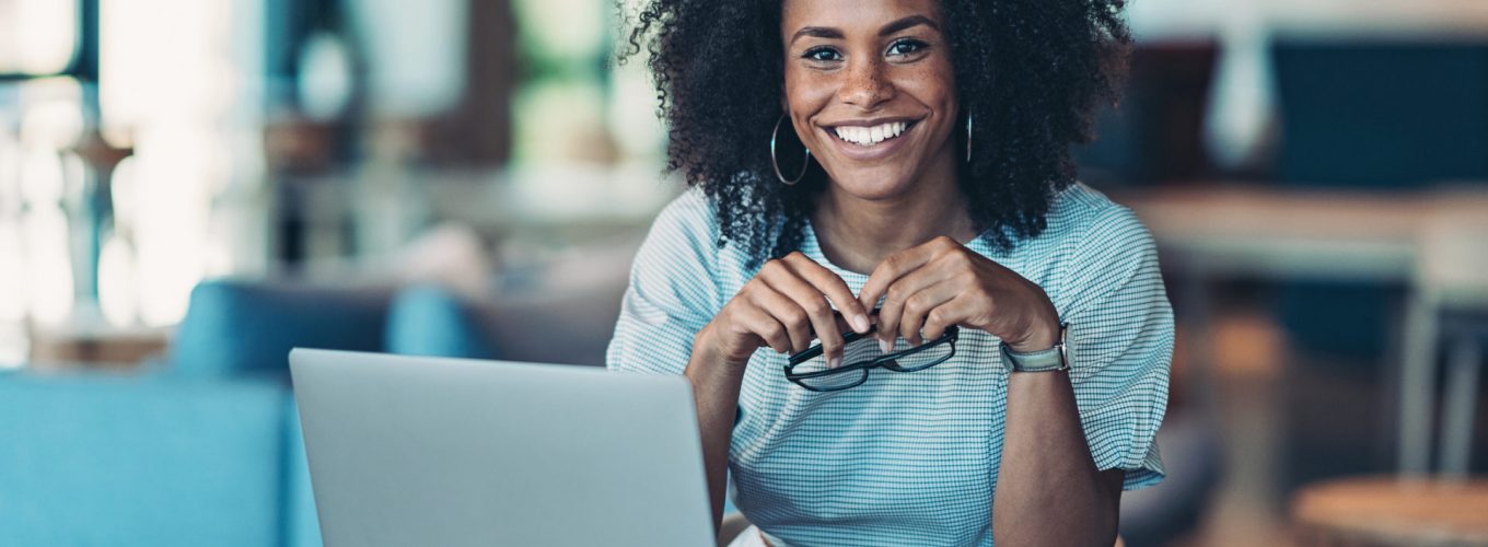 Portrait of a smiling businesswoman with a laptop in the office