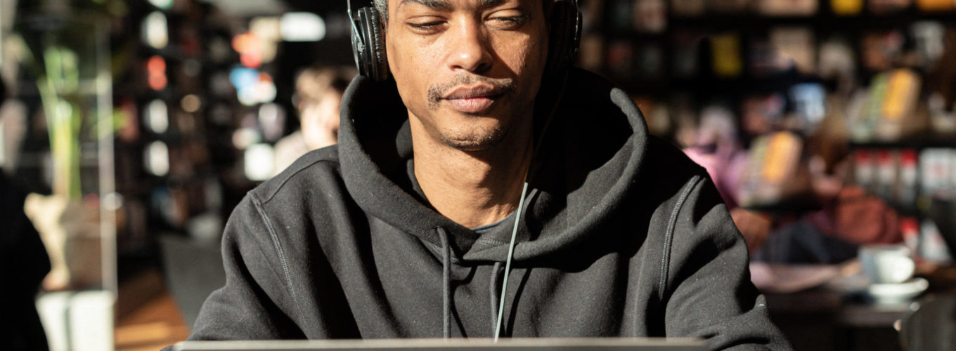 young black man is studying for an online degree on a laptop