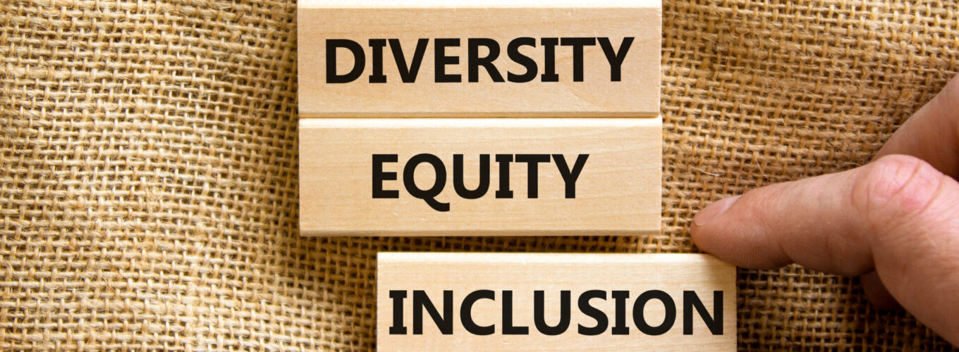 Diversity equity inclusion symbol. Concept words diversity equity inclusion on blocks on beautiful canvas table canvas background. Businessman hand. Business, diversity equity inclusion concept.