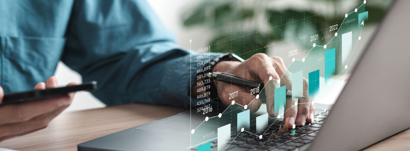 Businessman analyzing digital financial balance sheet of company working with digital virtual graphic design. Calculating long-term investment financial data icon on touch screen