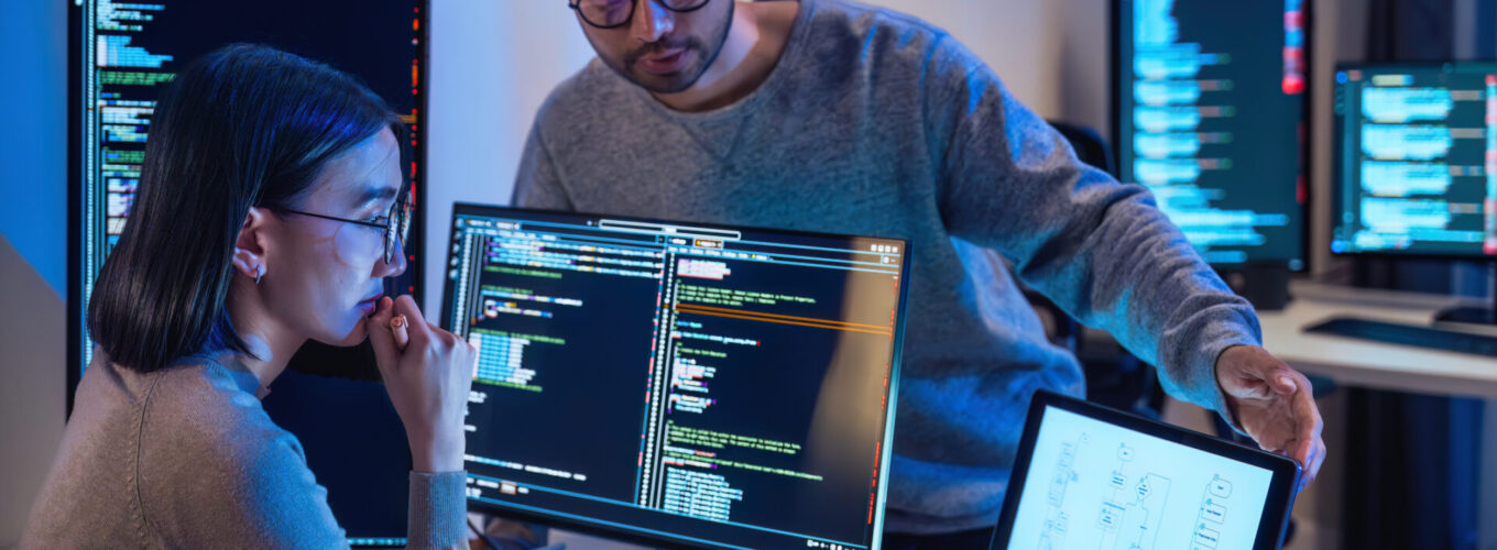 Developer  devops team discussion  about IT support with software computer at night in office