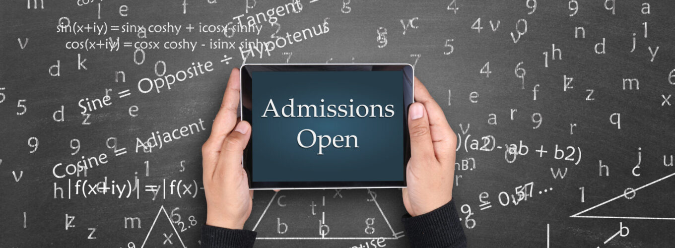 Directly above shot of a man holding digital tablet in front of blackboard. admissions open displayed on digital tablet. Math theory and mathematical formula equation written on blackboard.