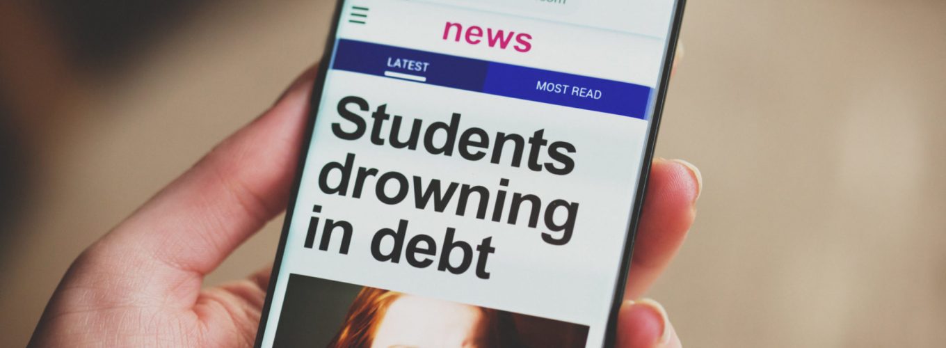 A mobile phone's screen shows a news item headlined 'students drowning in debt' illustrated by a miserable looking young girl. The photo and website design are by the photographer. The web address is fabricated.