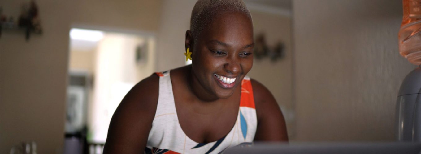 Portrait of mid adult woman using laptop at home